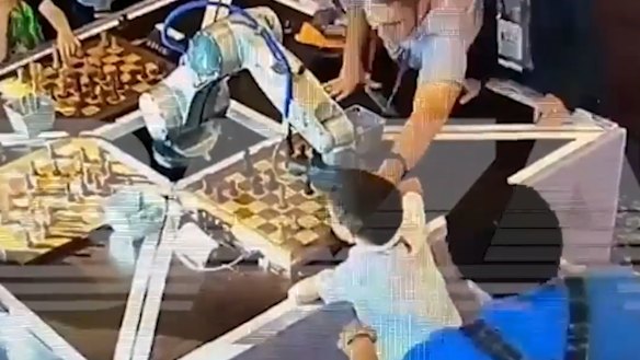 Chess robot meets child with a bad result.