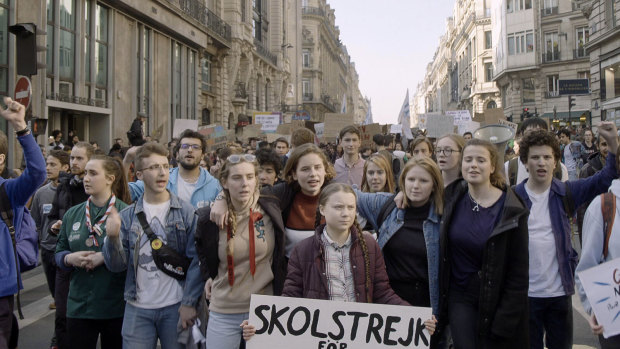 Greta Thunberg, centre, in a scene from the documentary "I Am Greta".