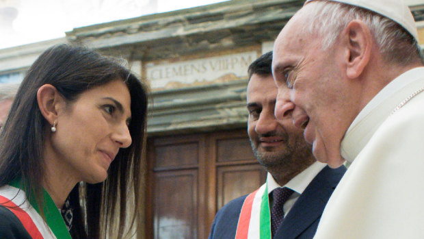 "Symbols of evil are dangerous": Pope Francis greets Mayor of Rome Virginia Raggi, left, as Naples' Mayor Luigi de Magistris looks on.