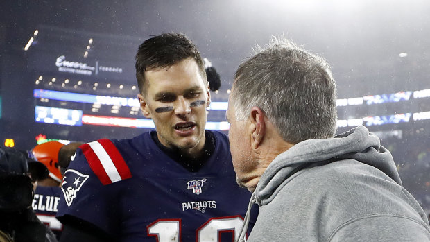 Tom Brady (left) congratulates Bill Belichick after his 300th NFL victory.