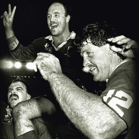 Wally Lewis is carried by Martin Bella (left) and Gene Miles after victory at the Football Stadium, 14 June 1989.