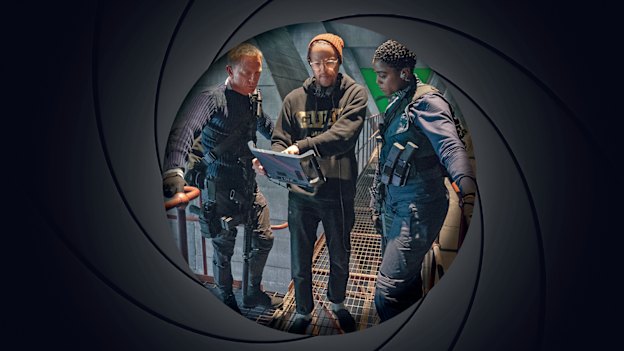 Cary Joji Fukunaga guides Daniel Craig and Lashana Lynch through a scene in No Time to Die. 
