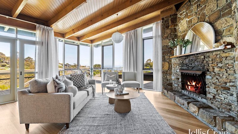 This mid-century beach home with bay views is made of stone, timber and good vibes