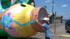 Heritage Bank mascot Priscilla the Pig and a young fan at the Nanango Mardi Gras.