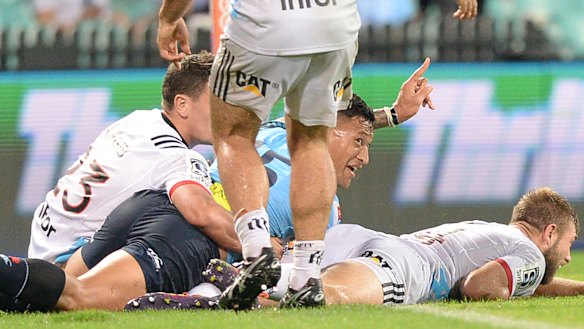 Salute: Israel Folau claims a try after crossing against the Crusaders at the SCG.