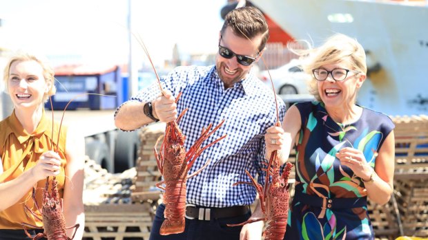 Liberal candidate for Fremantle Miquela Riley, Opposition Leader Zak Kirkup and Deputy Leader Libby Mettam handling rock lobsters at the Fremantle fishing harbour.