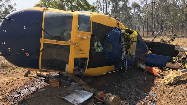 The wreckage of a helicopter that had been deployed to fight fires north of Toowoomba on Wednesday. The pilot escaped with minor injuries.