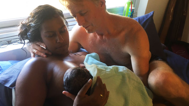 Amrita Kapur is supported by her husband Paul Keogh at their Coogee home moments after she gave birth to Ishani.