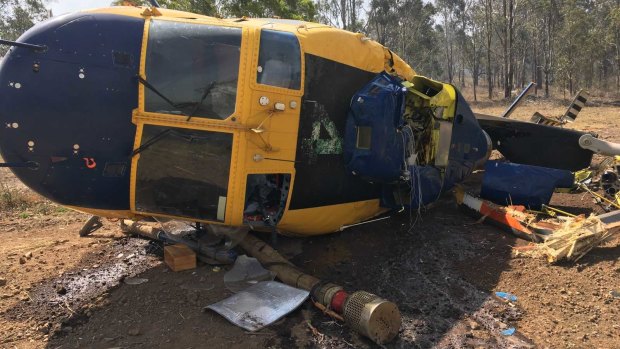 The wreckage of a helicopter that had been deployed to fight fires north of Toowoomba on Wednesday. The pilot escaped with minor injuries.