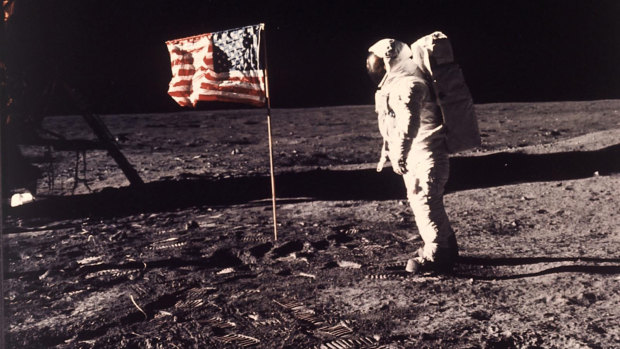 Astronaut Edwin "Buzz" Aldrin poses for a photograph beside the US flag planted on the moon during the Apollo 11 mission on July 20, 1969. 
