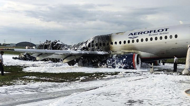 The Aeroflot Sukhoi SSJ100 aircraft is covered in fire retardant foam after an emergency landing at Sheremetyevo Airport in Moscow, Russia.