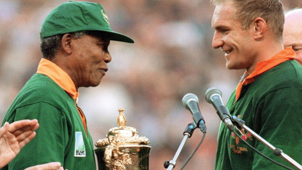 Nelson Mandela presents Francois Pienaar with the World Cup at Ellis Park.