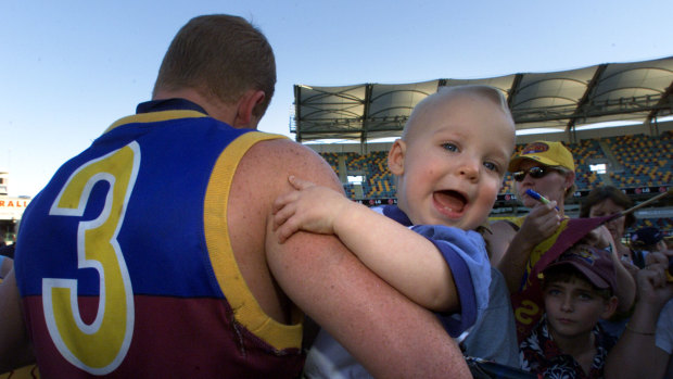 Michael Voss with his son Casey, then 1, at the Gabba.