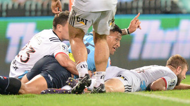 Salute: Israel Folau claims a try after crossing against the Crusaders at the SCG.