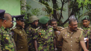 Sri Lankan police and army officers display bomb making materials recovered from a hideout of militants after Friday's gun battle.