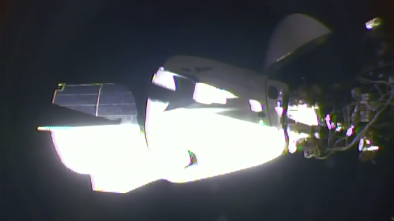 US astronauts on SpaceX Dragon capsule dock on ISS