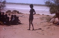 Yuwali walks to her group at Kutararra on the Percival Lakes, Great Sandy Desert, in 1964. 