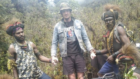 Papuan separatist rebels pose with New Zealander pilot Phillip Mark Mehrtens who they took hostage last week, at an undisclosed location in Papua province, Indonesia.
