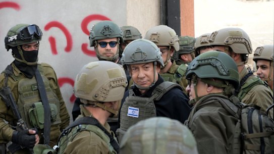 Israeli Prime Minister Benjamin Netanyahu receives a security briefing in the northern Gaza Strip on December 25.