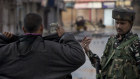 In this Aug. 8, 2019, photo, an Indian Paramilitary soldier orders a Kashmiri to lift his robe before frisking him  during curfew in Srinagar, Indian controlled Kashmir. The lives of millions in India's only Muslim-majority region have been upended since the latest, and most serious, crackdown followed a decision by New Delhi to revoke the special status of Jammu and Kashmir and downgrade the Himalayan region from statehood to a territory. Kashmir is claimed in full by both India and Pakistan, and rebels have been fighting Indian rule in the portion it administers for decades. (AP Photo/Dar Yasin)
