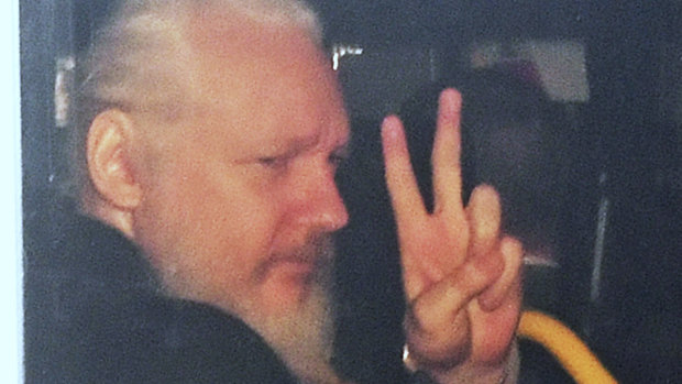 Julian Assange gestures as he arrives at Westminster Magistrates' Court in London.