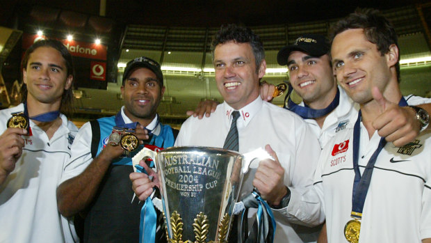 Shaun Burgoyne (second from right) and Gavin Wanganeen (right) celebrate Port Adelaide's 2004 premiership.