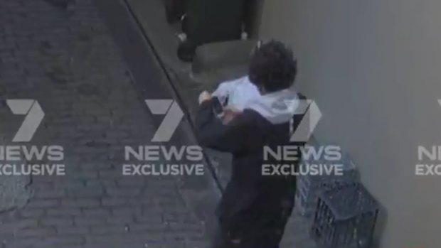 Mert Ney is captured via CCTV in the laneway near Clarence Street.