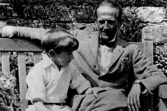 A.A. Milne sits by his books’ hero, son Christopher Robin, in 1952.