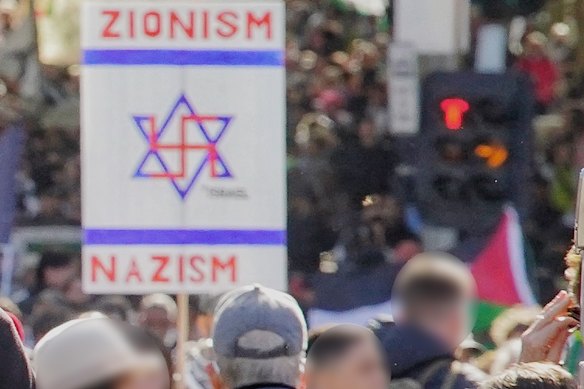 A sign juxtaposing Zionism and Nazism is displayed at a pro-Palestinian rally last May in Melbourne. 