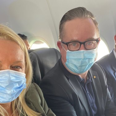 Happy with the middle seat in an early flight back in June: Qantas chief executive Alan Joyce, centre, with chief customer officer Steph Tully and Qantas International chief executive Tino La Spina.