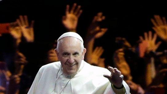 Pope Francis waves to the crowd during a parade in Philadelphia on September 26, 2015.