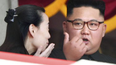 North Korean leader Kim Jong Un  talks with his sister Kim Yo Jong, during a parade for the 70th anniversary of North Korea's founding day.