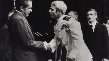 In this May 25, 1973, file photo, US Navy Lieutenant Commander John McCain is greeted by President Richard Nixon, left, in Washington, after McCain's release from a prisoner of war camp in North Vietnam. 