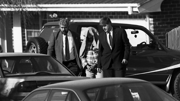 Police taking away Ivan Milat from his Eaglevale home after an early morning raid in 1994.
