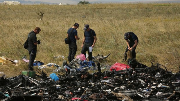 Australian Federal Police officers and their Dutch counterparts search for human remains and personal belongings from the MH17 crash site.