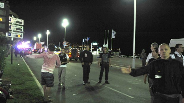 Members of the public walk along the promenade in Nice in 2016 after the truck attack.