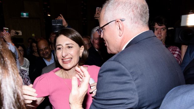 NSW Premier Gladys Berejiklian is congratulated by Scott Morrison as she enters the ballroom of the Sofitel Wentworth on election night. 