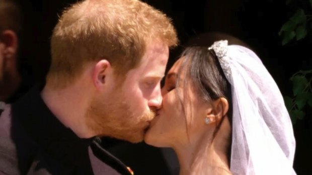 The Duke and Duchess of Sussex's first kiss as a married couple.
