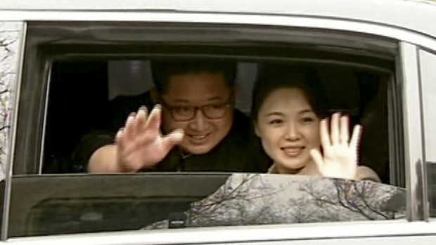Kim Jong-un and his wife Ri Sol-ju wave from a car as they bid farewell to Chinese counterpart Xi Jinping and his wife Peng Liyuan in Beijing.