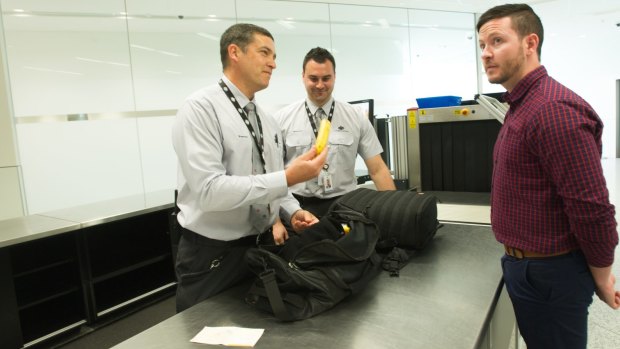 Biosecurity officers monitoring bags at the luggage check point. 