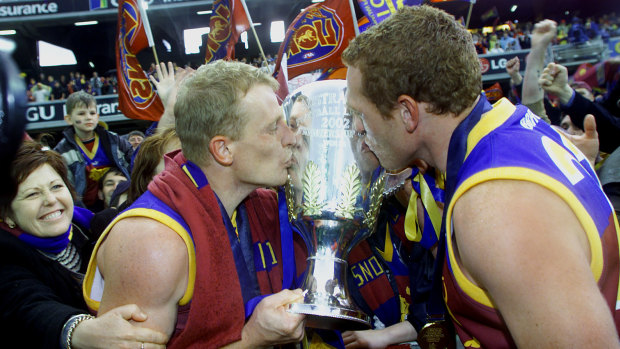 Michael Voss and Justin Leppitsch celebrate winning the 2002 AFL premiership.