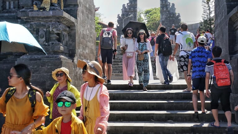 Chinese tourists dominate the scene at Tanah Lot.