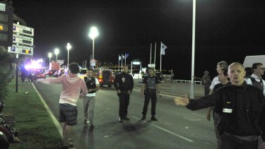 Members of the public walk dazed along the promenade in Nice in 2016, in the confusion that followed the truck attack.