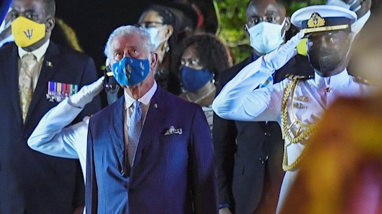 Prince Charles watches as the British royal standard is folded after it is lowered in Bridgetown, Barbados, on Tuesday.