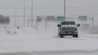 Vehicles driving on snow-covered Interstate 10 in Houston on Monday.