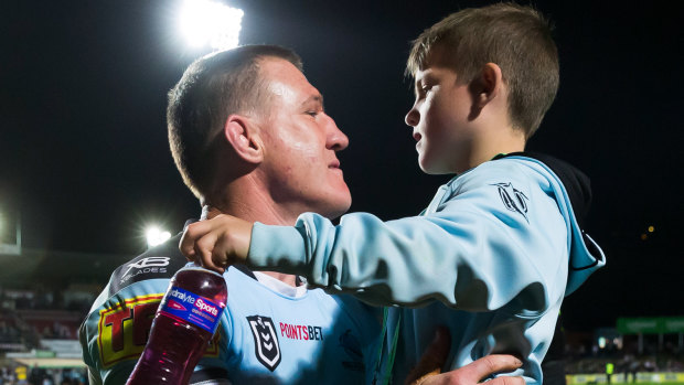 Family affair: Gallen embraces his son after the match.