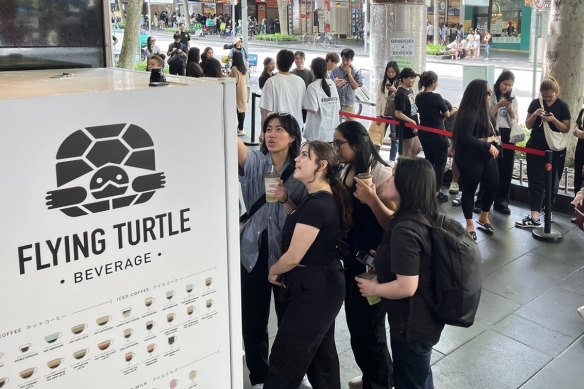 A crowd lines up to try Flying Turtle drinks automation machine.