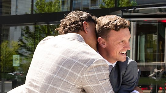 Mitchell and Wighton embrace after addressing the media outside the ACT Magistrates Court.