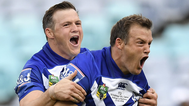 Josh Morris of the Bulldogs (right) celebrates with brother Brett (left) after scoring a try.