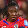 Melchie Dumornay takes a shot past England captain Millie Bright.
